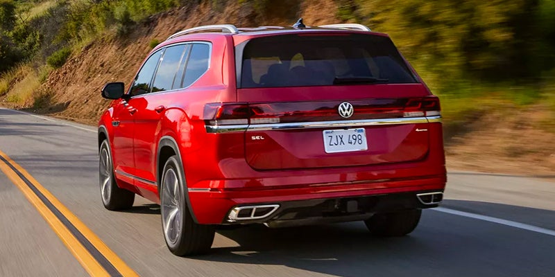 Rear view of a red Volkswagen SUV driving on road